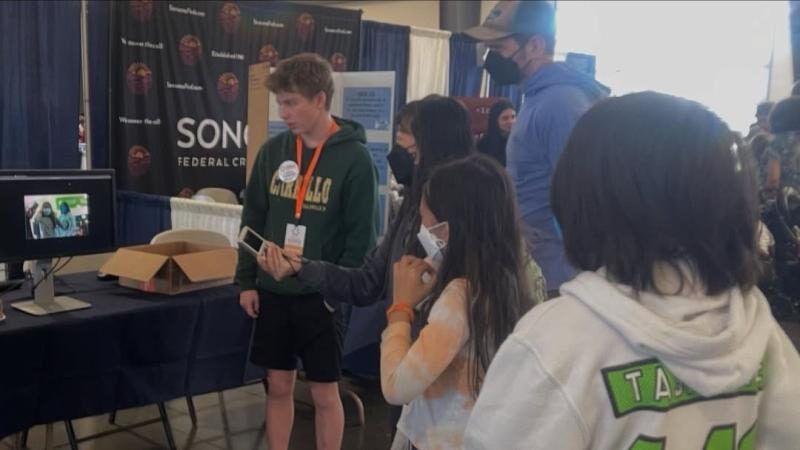 Wiley demoing the object detection app to visitors at an expo booth
